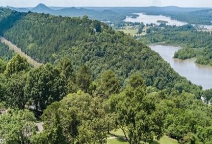 Green grassy mountains winding down to a river